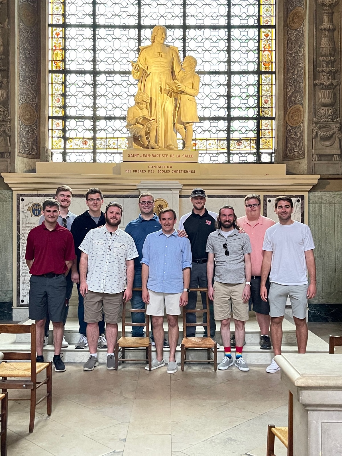 Alumni Vocal Ensemble in front to De La Salle statue in France